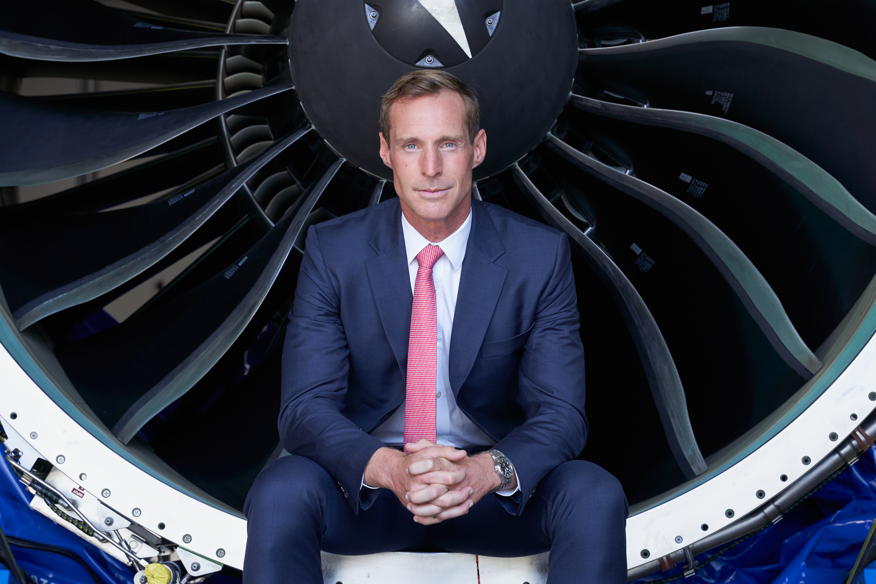 Austin Willis, CEO of Willis Lease Finance Corporation, sitting in a plane engine